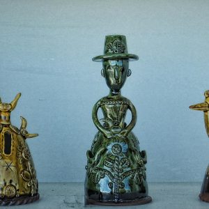 Unique ceramic sculptures creatively displayed indoors, showcasing intricate designs and vintage charm.