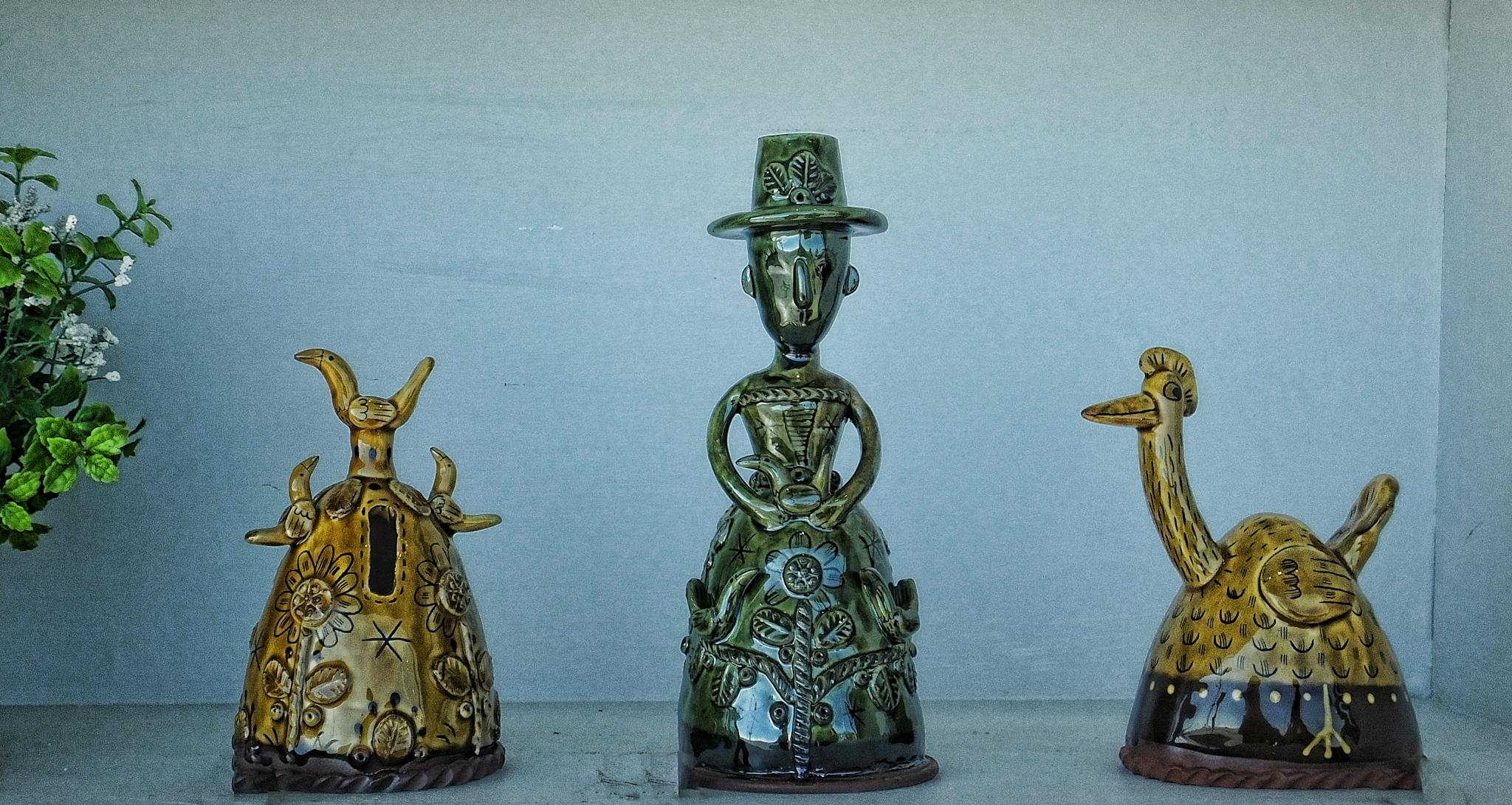 Unique ceramic sculptures creatively displayed indoors, showcasing intricate designs and vintage charm.